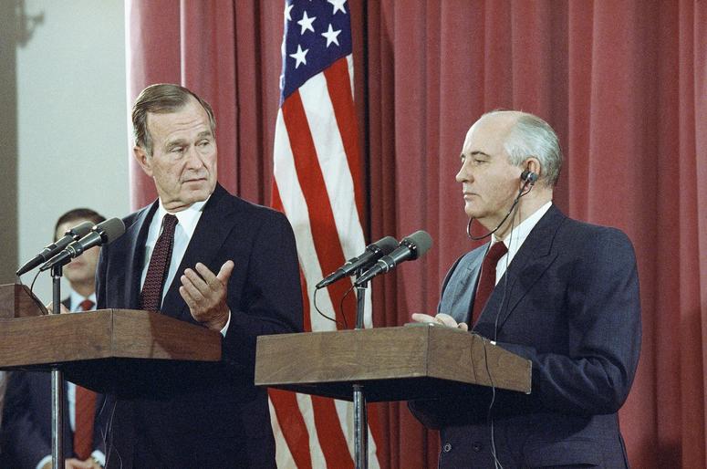 Bush gestures during a joint news conference with Soviet President Mikhail Gorbachev, at the Soviet Embassy in Madrid on Oct. 29, 1991.