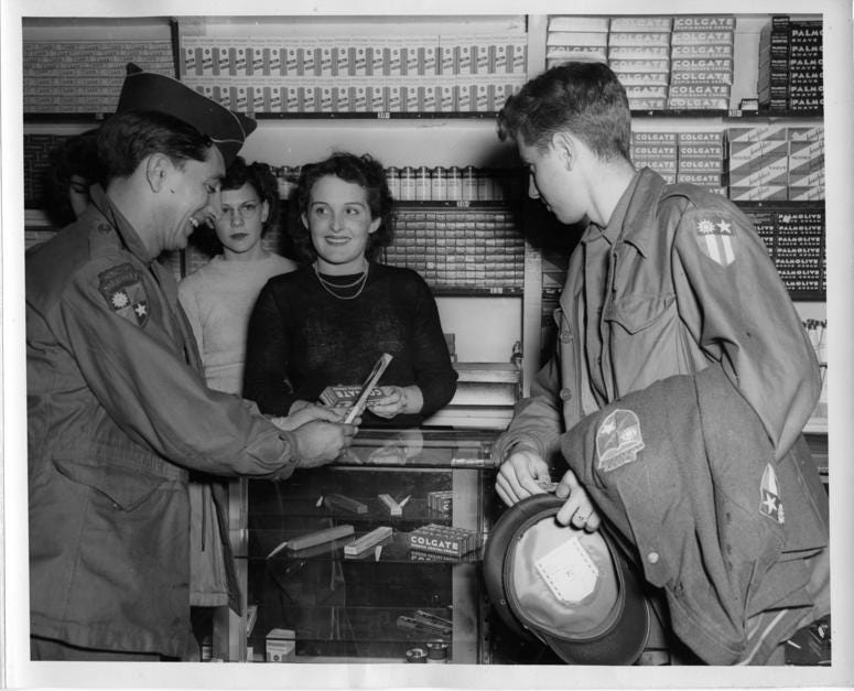 Just back from the China-Burma-India Theater of Operations, (left) Pfc. Joseph Colaci and Pvt. Sam J. Rayner, both members of Merrill's Marauders, purchase tooth paste, tooth brushes and other items at the main Post Exchange, Camp Patrick Henry, Va. MerrillsMarauders