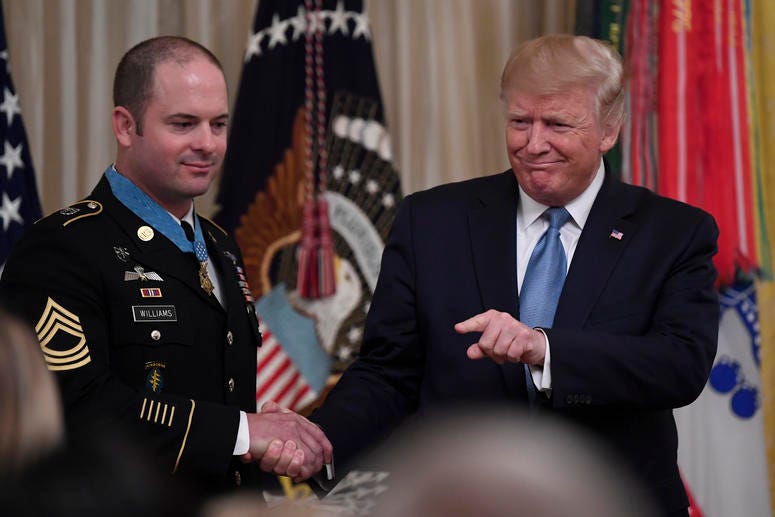President Donald Trump, right, shakes hands with U.S. Army Master Sgt. Matthew Williams, left, currently assigned to the 3rd Special Forces Group. President Donald Trump, right, shakes hands with U.S. Army Master Sgt. Matthew Williams, left, currently assigned to the 3rd Special Forces Group.