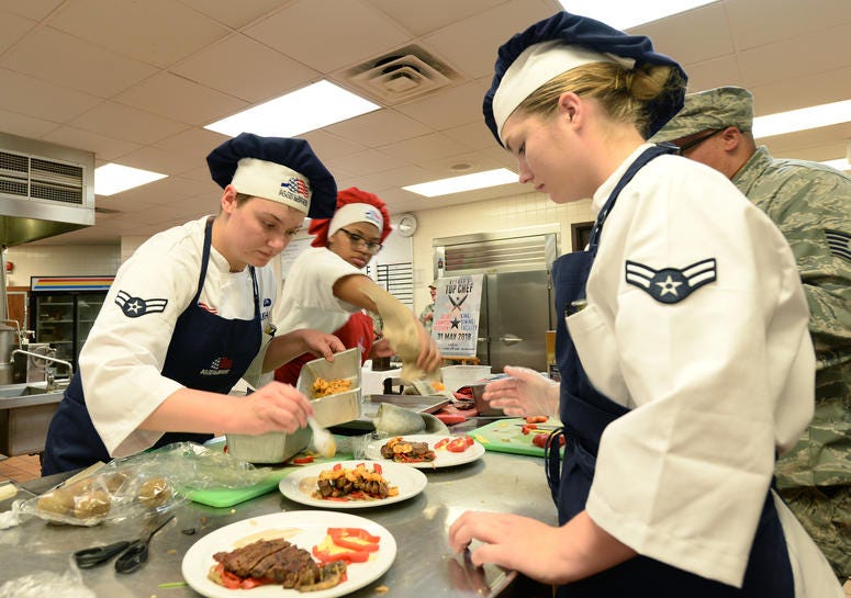 Teammates Airman 1st Class Aubry Burkhardt, Airman 1st Class Madison Farley and Airman Aminah Griffin, 55th Force Support Squadron Sustainment Flight food service apprentices, compete in a top chef competition May 31, 2018 at Offutt Air Force Base, Nebras