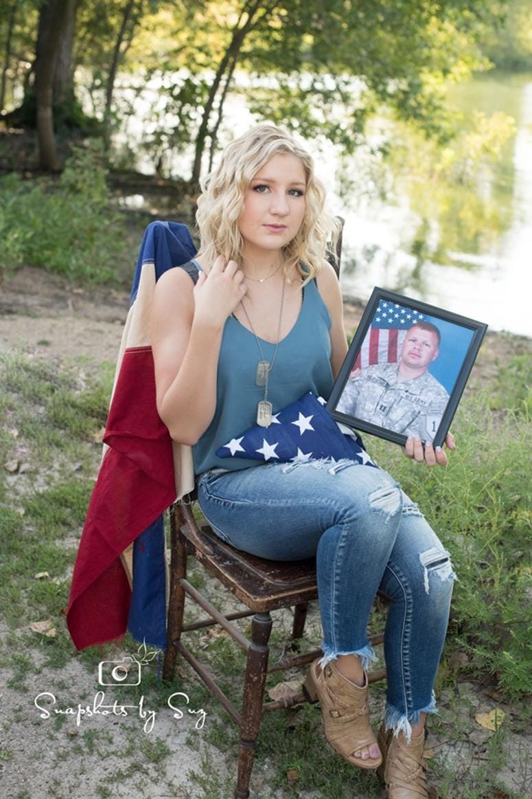 Julia Yllescas with a photo of her dad, Capt. Robert Yllescas, who died in 2008, Dadphotos