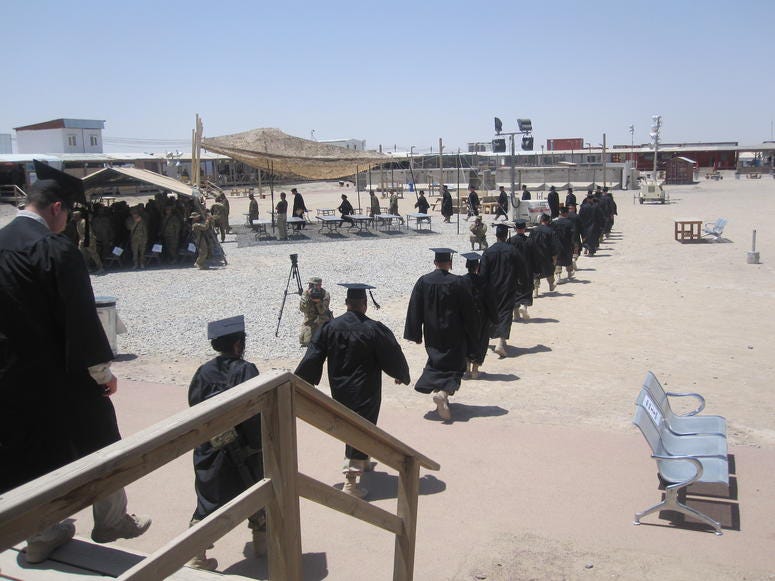 UMUC Graduates on the march during a commencement ceremony on a U.S. base in Kandahar, Afghanistan, May 25, 2012. UMUC Graduates on the march during a commencement ceremony on a U.S. base in Kandahar, Afghanistan, May 25, 2012.