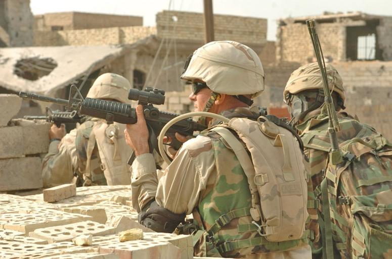 3rd Brigade Combat Team CSM John D. Fourhman joins scouts from the 2nd Battalion 2nd Infantry Regiment during a day of clearing operations during Operation Al-Fajr in Fallujah Nov. 15, 2004. 3rd Brigade Combat Team CSM John D. Fourhman, fires at insurgents, during Operation Al-Fajr in Fallujah November 2004