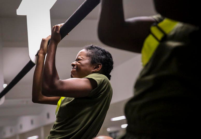 U.S. Marine Corps recruits with Platoon 4038, Papa Company, 4th Recruit Training Battalion, execute pull-ups during their Initial Strength Test on Parris Island July 20, 2018. The minimum physical requirements for female recruits to begin training are 44