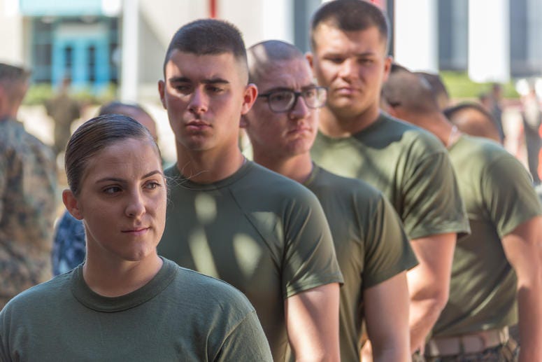 U.S. Marine Pfc. Kira Kozik, the first female Marine student to check in to School of Infantry – West, stands in line to turn in her medical records on Camp Pendleton, March 6, 2018. This marks the first male-female integrated Marine Combat Training compa