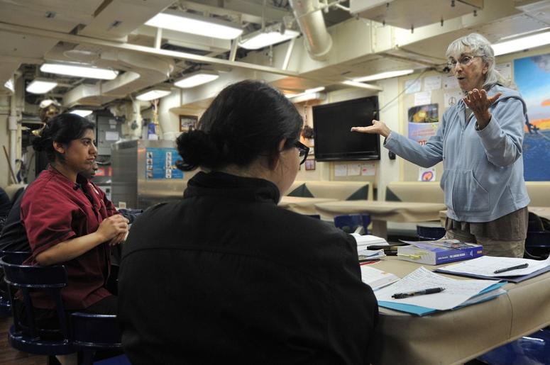 Wendy Pollitt, an English teacher with the Navy College Program for Afloat College Education, teaches sailors aboard the Arleigh Burke-class guided-missile destroyer USS McCampbell (DDG 85) in the Philippine Sea in 2012. NCPACE