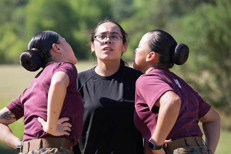 A poolee from Recruiting Station San Antonio gets yelled at by two drill instructors during an all-female pool function at Camp Bullis, Texas, July 22. Pool functions are held to prepare future Marines for the physical and mental stress of Marine Corps re