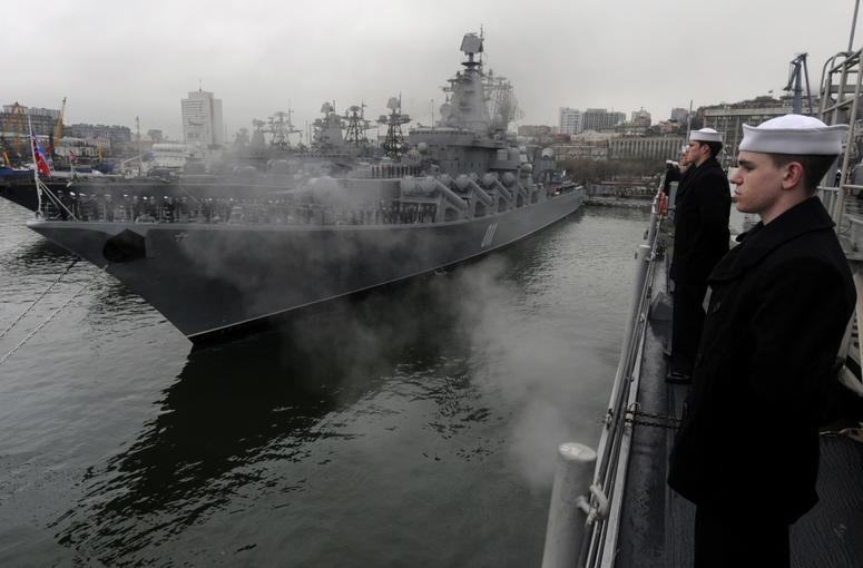 Fireman Nathan Kander, machinist's mate, mans the rails aboard the U.S. 7th Fleet command ship USS Blue Ridge as the ship pulls into Vladivostok, Russia.