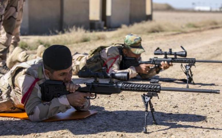 Iraqi soldiers assigned to 74th Brigade practices a proper prone firing position with the M40A6 sniper rifle during weapons familiarization training at Camp Taji, Iraq, March 11, 2018. sniper