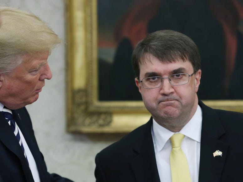 President Donald Trump (L) congratulates Robert Wilkie (R), during a swearing-in ceremony to become Secretary of the Department of Veterans Affairs, in the Oval Office at the White House, on July 30, 1018 in Washington, DC.