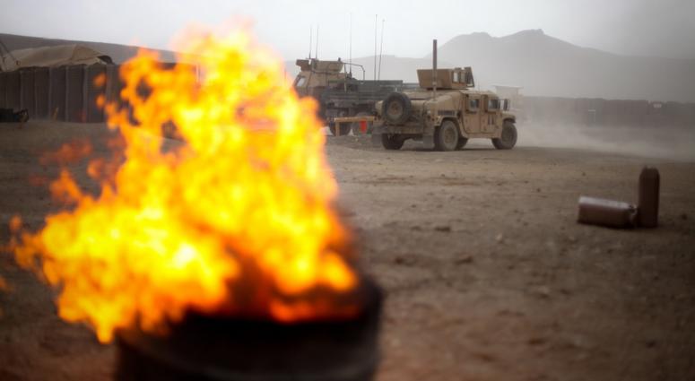 The flames of a burn pit picks up with the winds as a storm approaches Combat Outpost Tangi in the Tangi Valley, Afghanistan, Aug. 31, 2009. BurnPits5