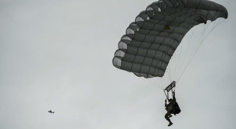 A military-free-fall paratrooper lands as a United States Air Force CV-22 Osprey. Over 1,000 U.S. paratroopers participate in largest airborne operation since WWII to commemorate 75th anniversary of D-Day.