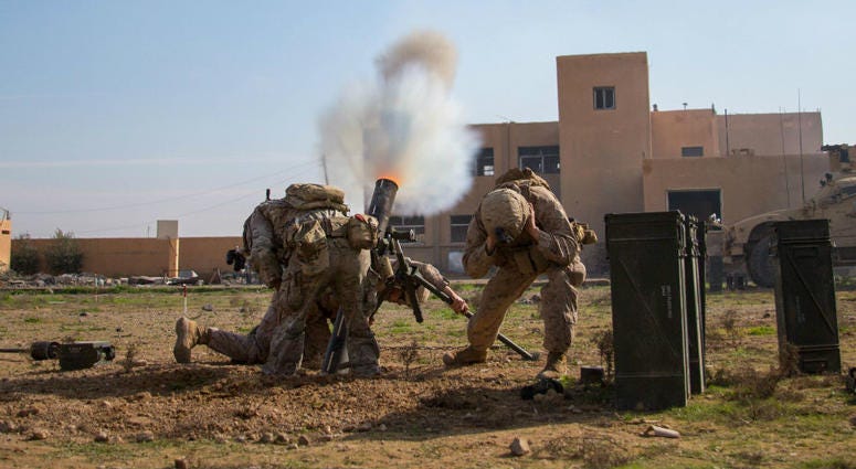 Coalition forces fire a 120mm mortar round at a known ISIS staging area . Operation_Inherent_Resolve