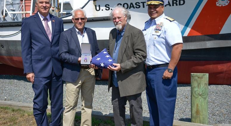 U.S. Representative Bill Keating, Bradley Finch, Stephen Finch, and Adm. Andy Tiongson pose for a photo
