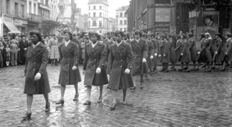 "Members of the 6888th Central Postal Directory Battalion take part in a parade ceremony in honor of Joan d'Arc at the marketplace where she was burned at the stake." May 27, 1945.Pfc. Stedman. 111-SC-426441.