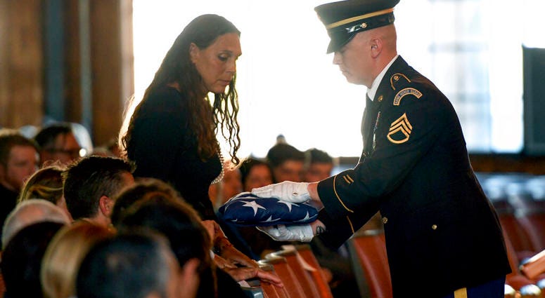 Natalie Henry-Howell, mother of Riley Howell, receives his flag from a military honor guard Student who charged a campus gunman remembered as a hero