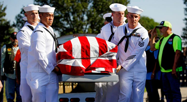 Sailors carry the casket of World War II veteran Herman White