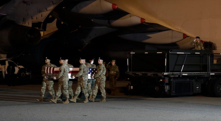 A U.S. Army carry team moves a transfer case containing the remains of Chief Warrant Officer 2 Kirk T. Fuchigami Jr. of Keaau, Hawaii, Thursday, Nov. 21, 2019, at Dover Air Force Base, Del. According to the Department of Defense, Fuchigami died in Afghani Trump pays respects to Army officers killed in Afghanistan