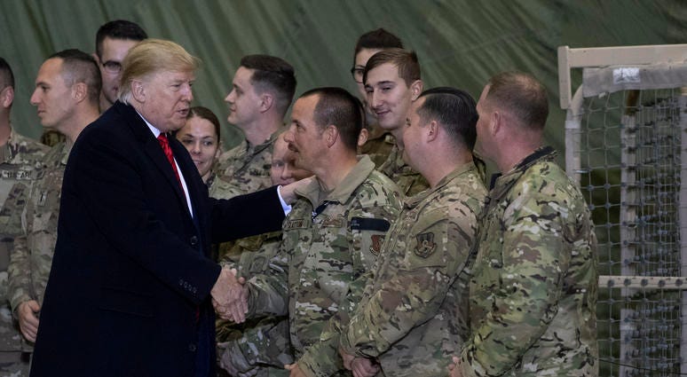 President Donald Trump greeting members of the military after speaking to members of the military during a surprise Thanksgiving Day visit. President Donald Trump greeting members of the military after speaking to members of the military during a surprise Thanksgiving Day visit.