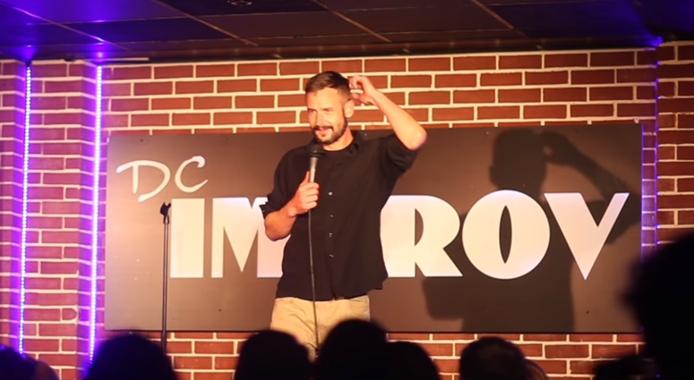 Combat-injured Marine Corps veteran Michael Garvey, who learned stand-up comedy skills in workshops presented by the Armed Services Arts Partnership, performs at a club in Washington, D. C.