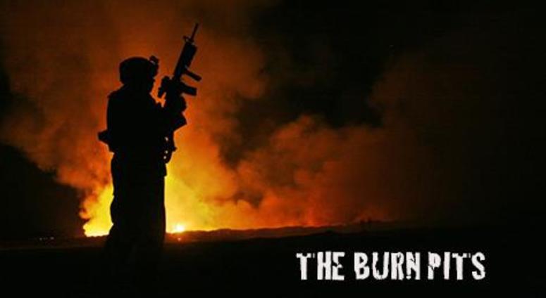 A soldier stands near one of the many open pits used in Iraq and Afghanistan to burn waste — some of it toxic — from nearby U. S. military bases.