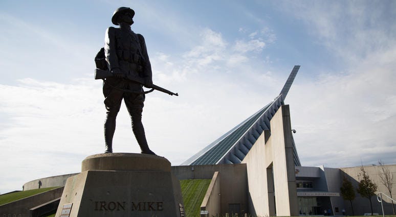 The National Museum of the Marine Corps is seen behind an "Iron Mike" statue.