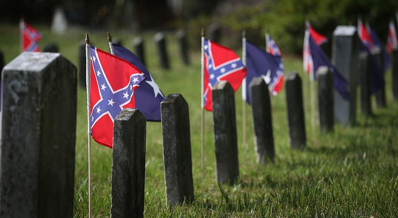 CHARLESTON, SC - JULY 14: Confederate flags fly over the graves of Confederate soldiers burried in Magnolia Cemetery on July 14, 2015 in Charleston, South Carolina. Some 3,000 Civil War veterans from South Carolina are reported buried in Magnolia Cemetery 200 Confederate flags removed from Woodbine Cemetery according to Sons of Confederate Veterans