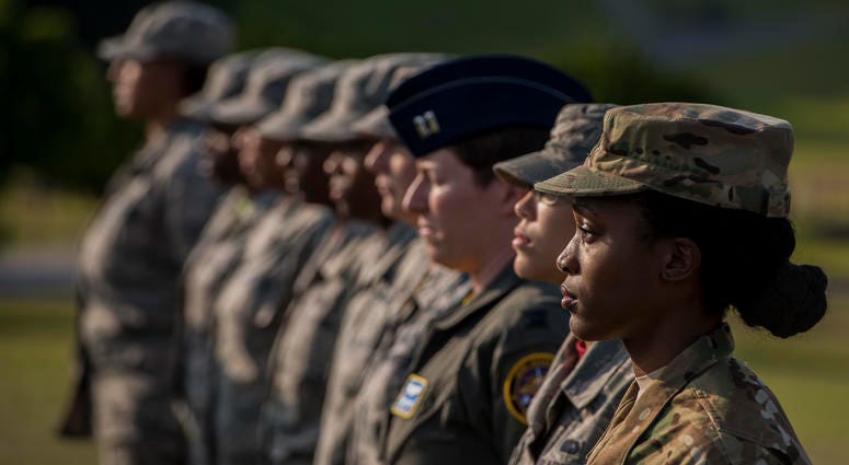 U.S. Air Force Airmen stand at attention during a retreat ceremony Mar. 30, 2018, on Kadena Air Base, Japan. An all-female formation was coordinated in honor of Women’s History Month, which brings attention to the accomplishments and achievements of women