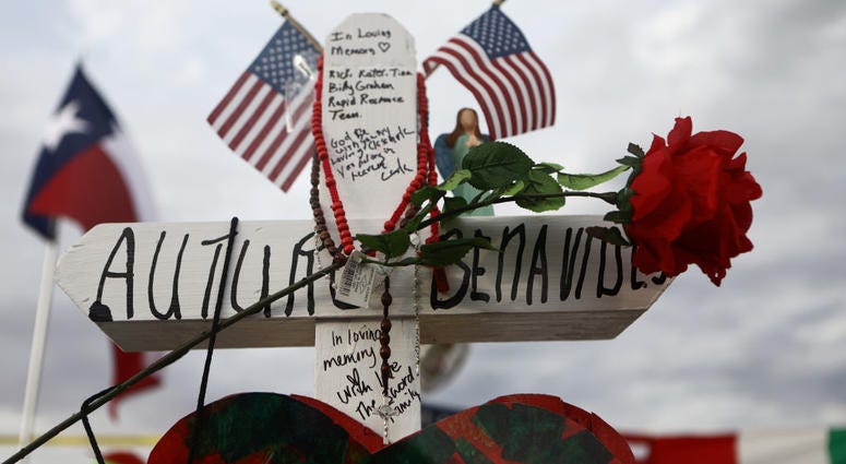 A cross honoring Arturo Benavides, 60, stands at a makeshift memorial for victims outside Walmart, near the scene of a mass shooting which left at least 22 people dead, on August 6, 2019 in El Paso, Texas. ElPasoBenavides