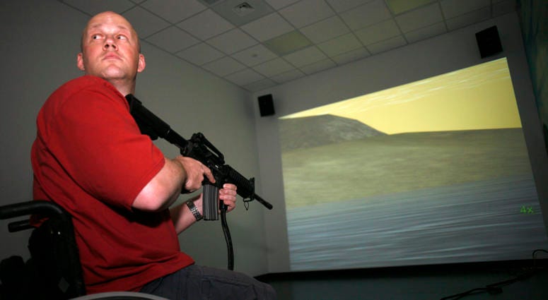 SAN ANTONIO, TX - MARCH 1: Petty Officer 2nd Class Chad Keuser, 33, uses a mock M4 assault rifle in simulator at the new high tech Center for the Intrepid rehab center for wounded veterans at Brooke Army Medical Center March 1, 2007 in San Antonio, Texas. Navy vet Chad Keuser uses a mock M4 assault rifle in simulator at the new high tech Center for the Intrepid rehab center for wounded veterans at Brooke Army Medical Center March 1, 2007 in San Antonio, Texas.