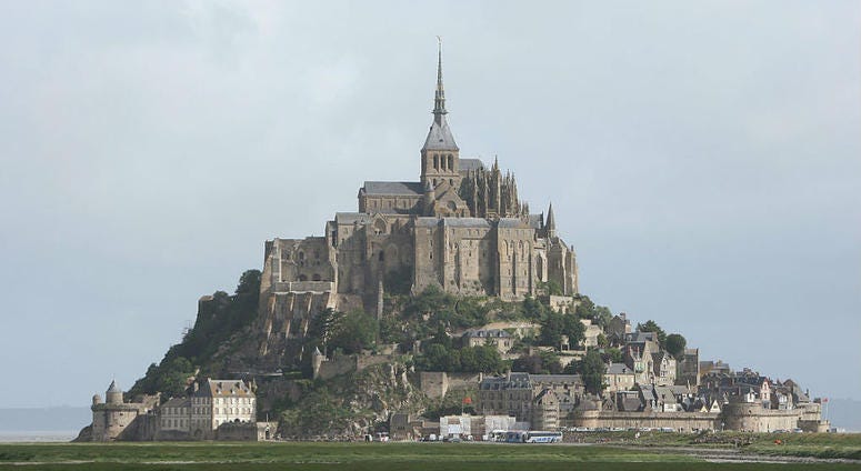 Sheep graze near the historic abbey at Mont St. Michel, France. U.S. Army Special Forces commorate WWII with jump at Mont St. Michel, France.