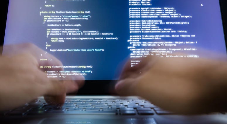 Close-up Of A Hacker's Hand Using Laptop Data Breach of Combat Veterans