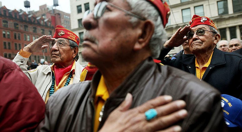 Members of the elite Navajo Code Talkers, the famed U.S. Marine unit who delivered unbreakable codes during World War II battles against the Japanese, salute before the start of the annual Veterans Day parade November 11, 2009 in New York City. CodeTalkers