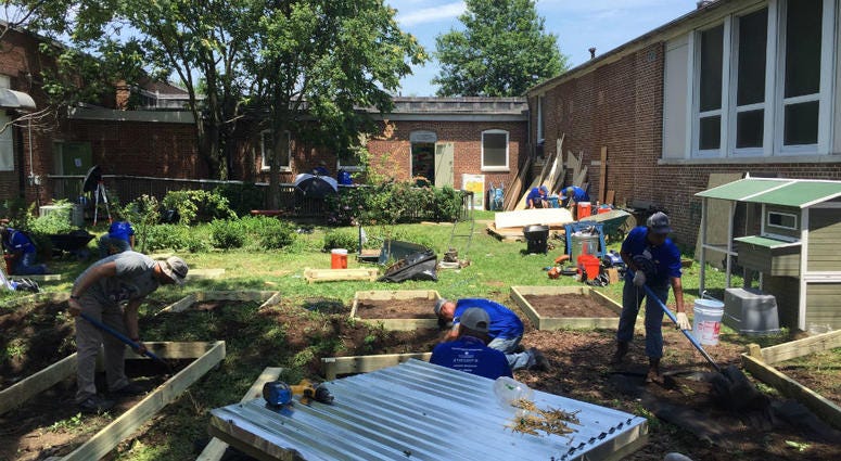 Veterans working to repair a courtyard at Ben Franklin High in Baltimore. 80 veterans from The Mission Continues at Ben Franklin High School in Baltimore.