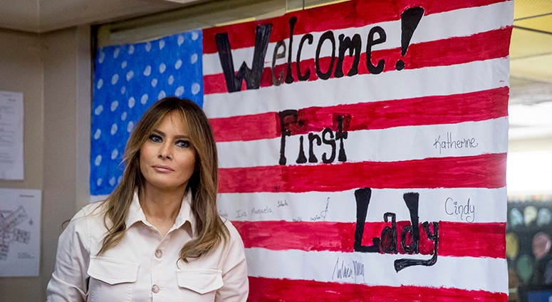 In this June 21, 2018 photo, First lady Melania Trump pauses after signing an artwork of an American flag while visiting the Upbring New Hope Children Center run by the Lutheran Social Services of the South in McAllen, Texas.