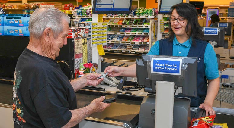 CHINA LAKE, CA., (July 17, 2019) Madison Chapman, China Lake Commissary Store Associate, assists a customer to check out after shopping. Base services are returning to normal following a 7.1 magnitude earthquake, which occurred near Naval Air Weapons Stat Commissary priveledges extended to disabled veterans per Department of Defense