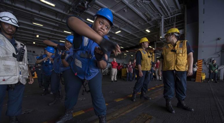 Sailors assigned to Deck Department handle line during a replenishment-at-sea with the Military Sealift Command's fleet replenishment oiler USNS Walter S. Diehl (T-AO 193) aboard the Navy™s forward-deployed aircraft carrier USS Ronald Reagan (CVN 76). The first all-female underway replenishment (UNREP) rig team during a replenishment-at-sea (RAS)