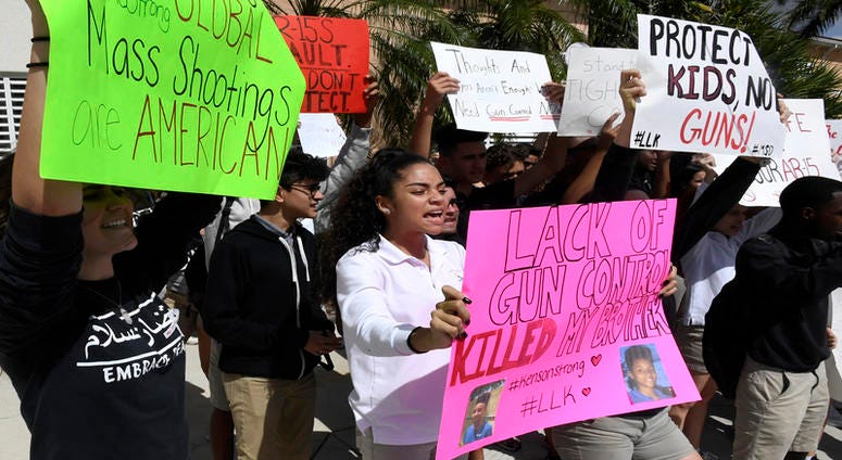 Pembroke Pines Charter High School students walk out of class to protest and read the names of the 17 people killed during the mass shooting at Parkland's Marjory Stoneman Douglas High School on Wednesday, Feb. 21, 2018.