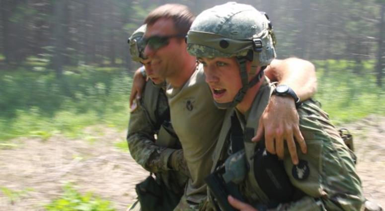 Spc. Ramon Puente, a combat medic specialist with the Headquarters and Headquarters Troop, 113th Cavalry Regiment, 2nd Infantry Brigade Combat Team, 34th Infantry Division, Iowa Army National Guard (IANG), buddy carries a simulated casualty. SpcRamonPuente