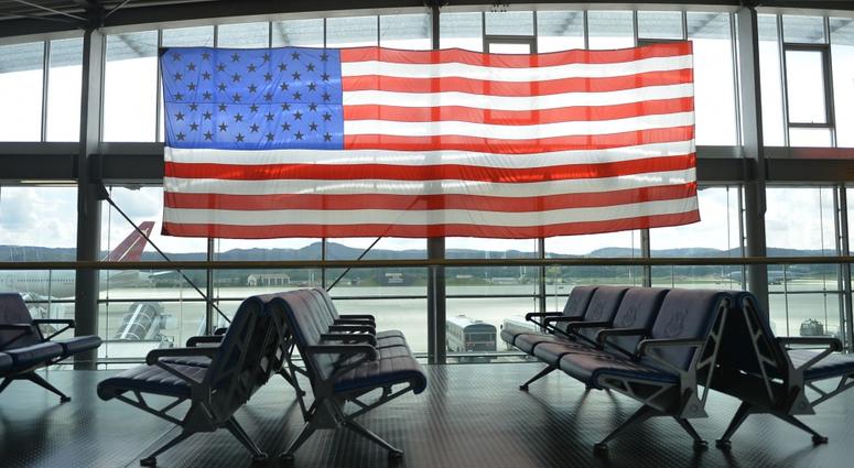 A U.S. flag hangs over the passenger terminal on Ramstein Air Base, Germany, Aug. 14, 2017.