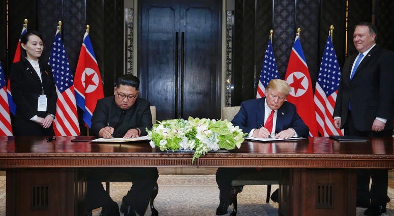 eader of the Democratic People's Republic of Korea (DPRK) Kim Jong Un (2nd L) and U.S. President Donald Trump (2nd R) sign a joint statement in Singapore on June 12, 2018.