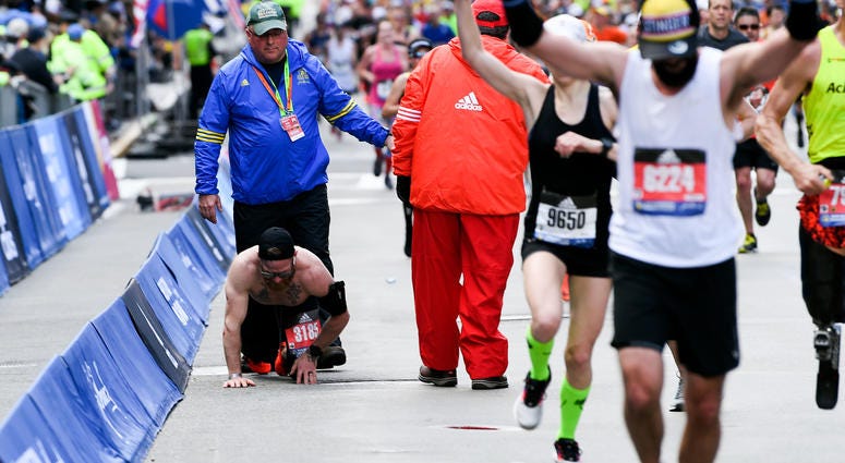 MicahHerndonBostonMarathon Apr 15, 2019; Boston, MA, USA; Micah Herndon crawls to the finish line of the 2019 Boston Marathon.
