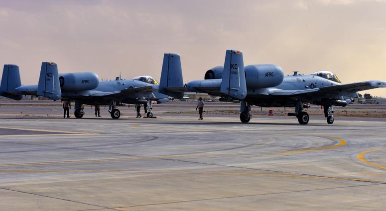 Crew chiefs and weapons Airmen assigned to the 303rd Expeditionary Fighter Squadron arm the weapons on two A-10 Thunderbolt IIs prior to takeoff at Kandahar Airfield, Afghanistan, Feb. 27, 2018.