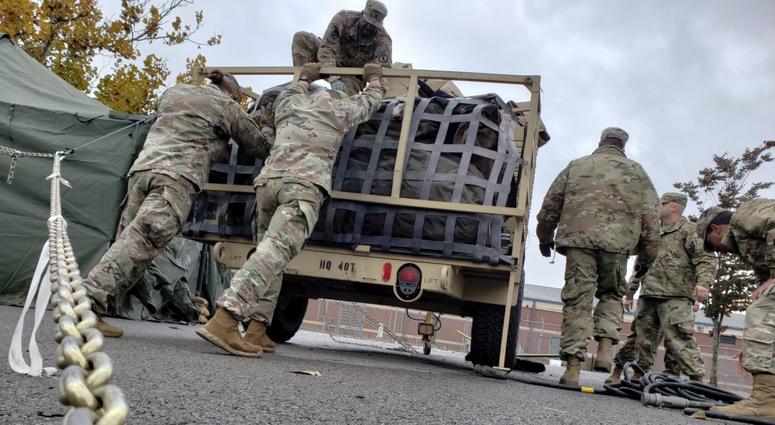 Soldiers from the 89th Military Police Brigade secure their equipment after loading it on a trailer at Fort Knox, Ky in preparation of a possible mission to support federal, state and local law enforcement agencies along the southwest border.