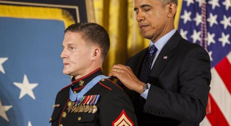 President of the United States, Barrack H. Obama places the Medal of Honor around retired U.S. Marine Corps Cpl. William Kyle Carpenter's neck, inside the East Wing of the White House, June 19, 2014.