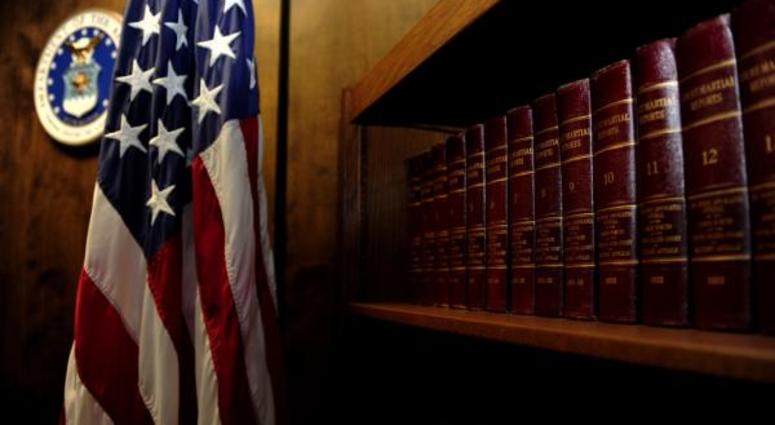 Volumes of “Court-Martial Reports” line the bookshelf located in the courtroom.
