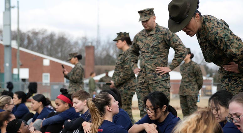 Female enlistees complete crunches as part of the Initial Strength Test during Recruiting Station New Jersey's enlistee training event Dec. 1, 2018 at Naval Weapons Station Earle in Colts Neck, N.J. The Initial Strength Test consists of pull ups or push u