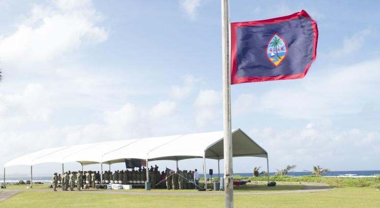 SANTA RITA, Guam, (Dec 19, 2018) Attendees of the Coastal Riverine Group (CRG) 1, Det. Guam change of charge ceremony stand during the presentation of the colors, singing of the national anthem and Guam hymn at Asan Beach War Memorial.