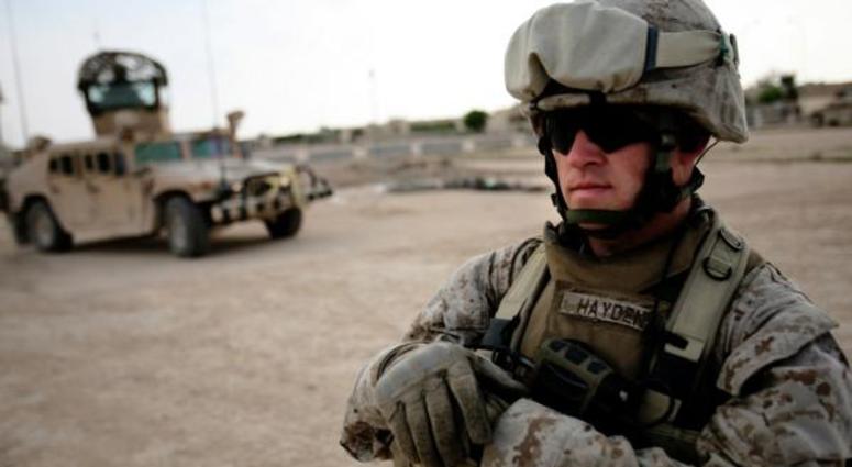 Sgt. Douglas Hayden, st Battalion, 2nd Marine Regiment, waits outside of an Iraqi police station Hayden, 32, from Fancy Farm, Ky., was a part of the initial invasion of Iraq and now is part of the transition phase. marine
