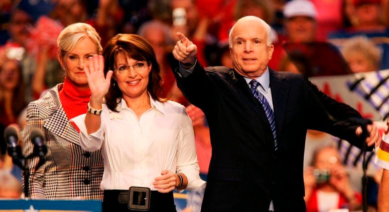 Republican pres. candidate John McCain responds to the crowd with his wife, Cindy McCain and running mate, Sarah Palin and her husband Todd Palin during a McCain-Palin rally at Virginia Beach Convention Center on Monday, October 13, 2008 .